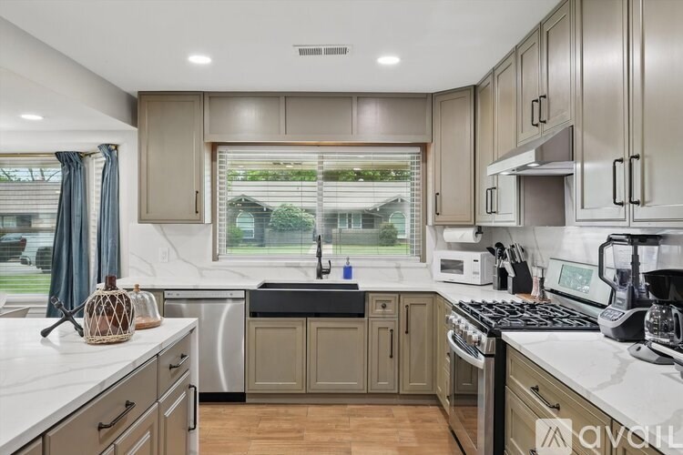 A kitchen with wooden cabinets and a white countertop.