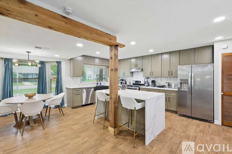 A modern kitchen with a dining table and chairs.