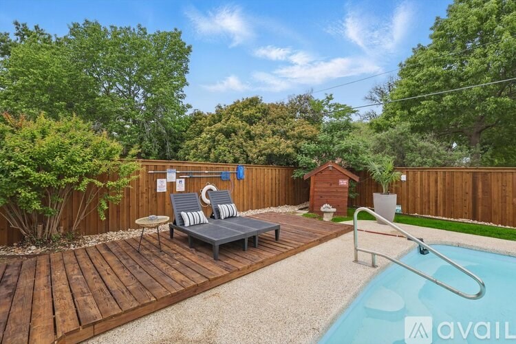 A backyard with a pool and deck.