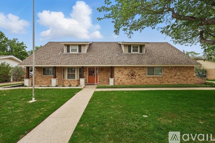 A house with a brown roof and a brown door is for sale.