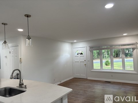 A kitchen with a sink and a window.