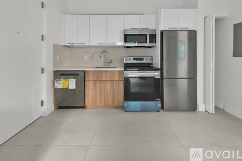A kitchen with white cabinets and stainless steel appliances.