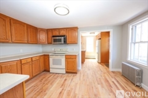A kitchen with wooden cabinets and a white oven.