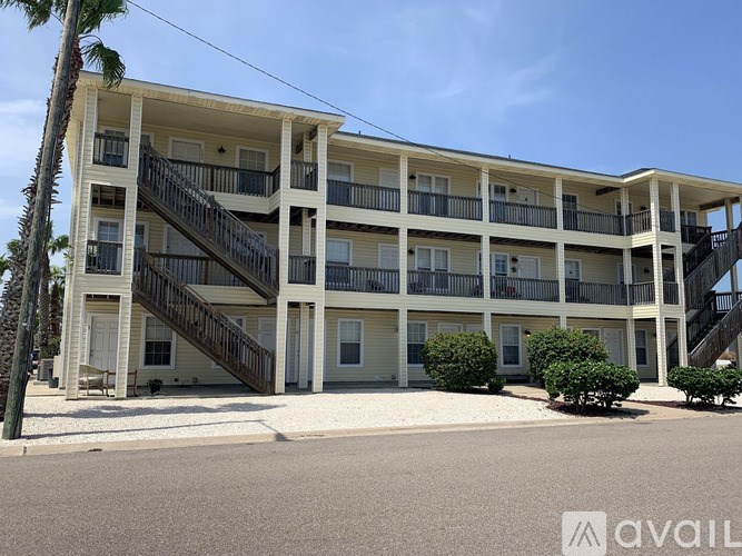 A multi-story building with balconies and staircases.