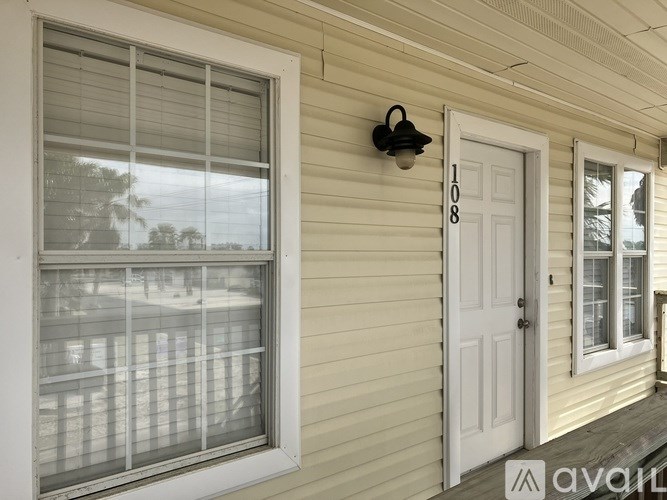 A house number 108 with a white door and window.