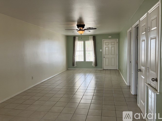 A room with a tiled floor and a ceiling fan.