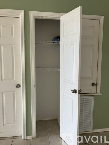 A white door is open to a small pantry.