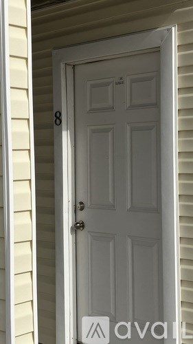 A white door with a number 8 above it.