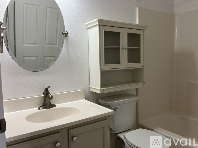 A bathroom with a sink, toilet, and medicine cabinet.