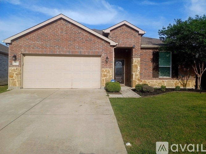 A brick house with a garage door and a driveway.