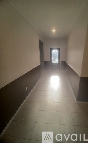 A long hallway with a light at the end.