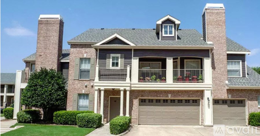 A large house with a grey roof and a balcony.