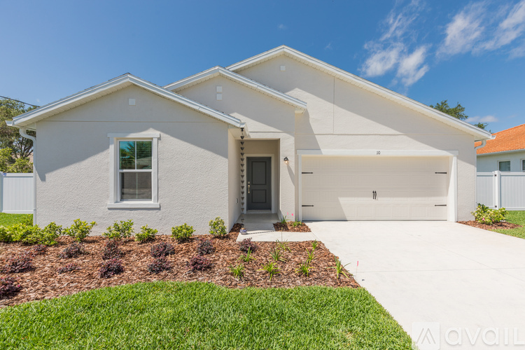 A modern house with a white exterior and a large front yard.