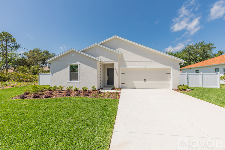 A modern house with a white exterior and a large front yard.