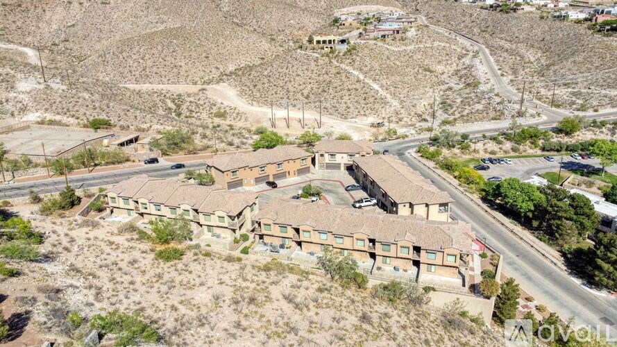 A large building complex sits in the middle of a desert.