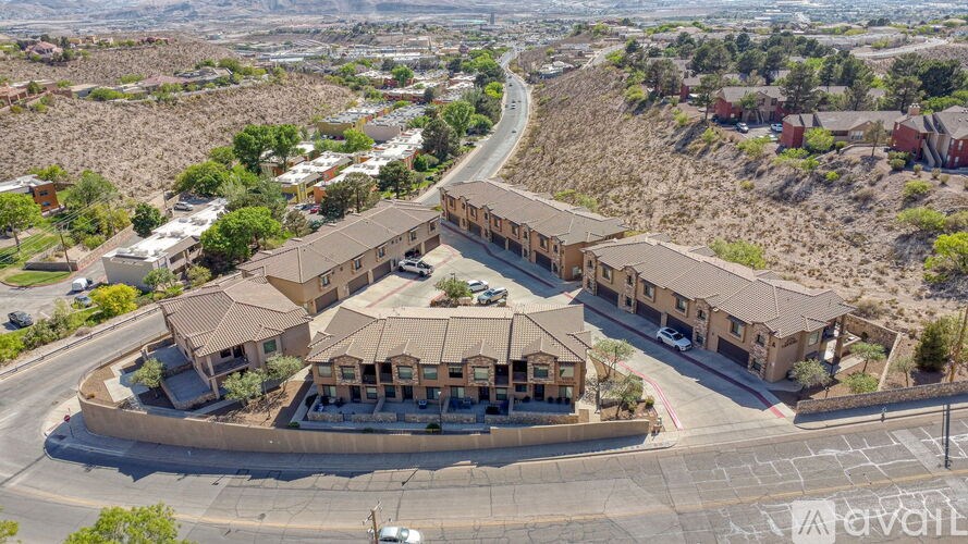 A bird's eye view of a housing development with a road running through the middle.