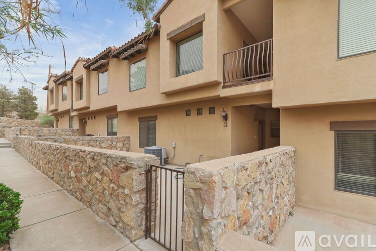 A row of houses with stone walls and balconies.