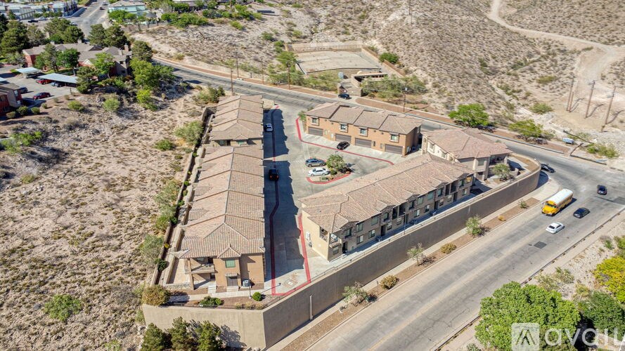 A road with cars and a building with a red roof.