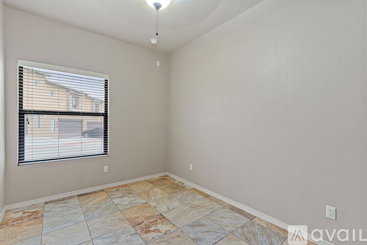 A room with a window and tiled flooring.