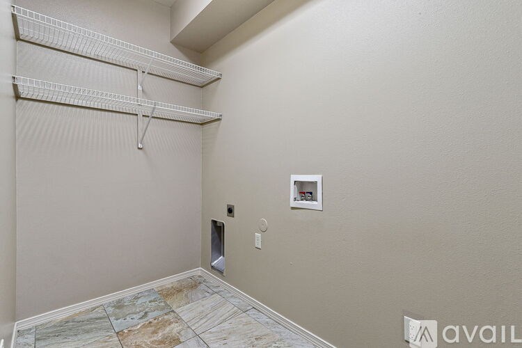 Empty room with a wall-mounted shelf and a tile floor.
