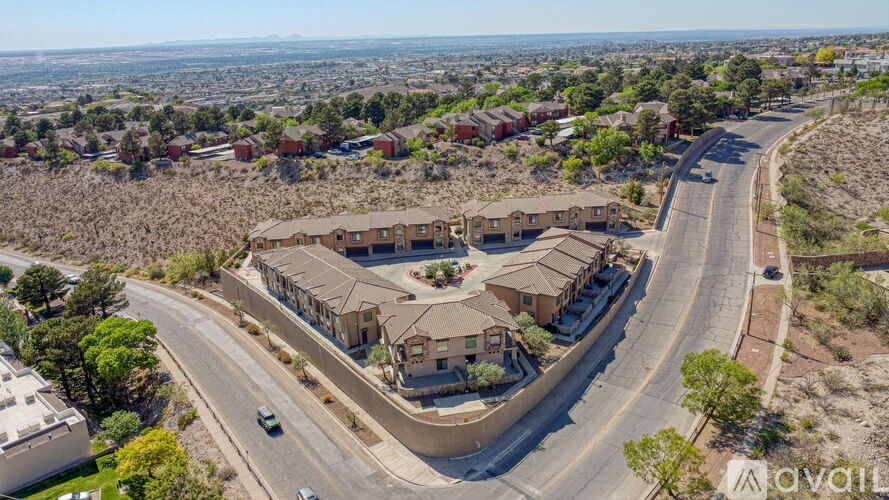 A bird's eye view of a residential area with houses and a road.