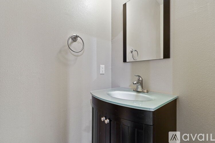 A bathroom with a sink and a mirror.