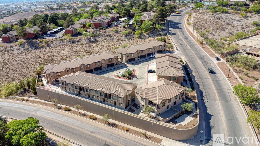 A large apartment complex with a parking lot in front.