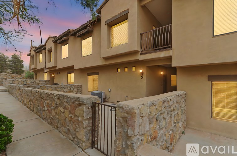 A row of houses with stone walls and balconies.