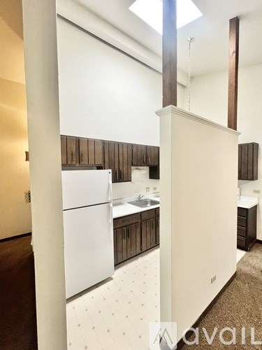 A kitchen with white cabinets and a wooden backsplash.