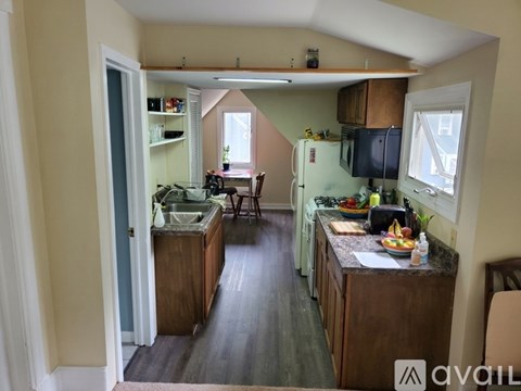 A kitchen with a table and chairs in the middle of the room.