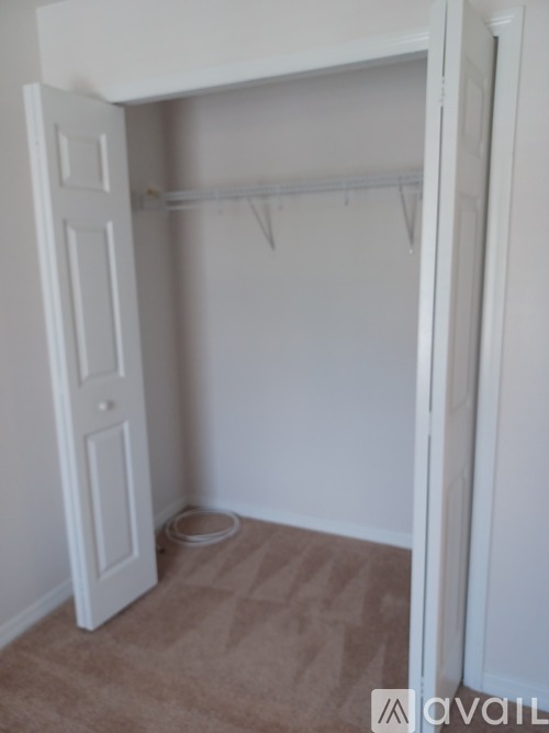 A white closet with a bowl on the floor.