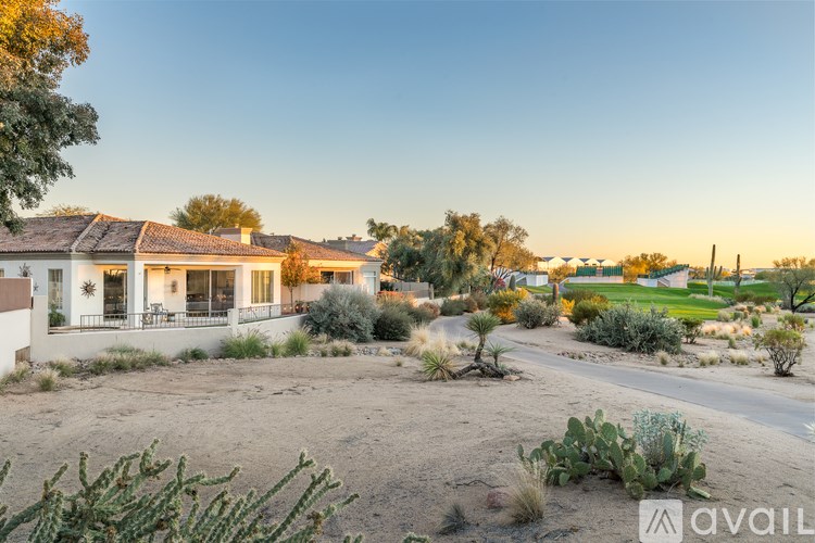 A house with a cactus in front of it.