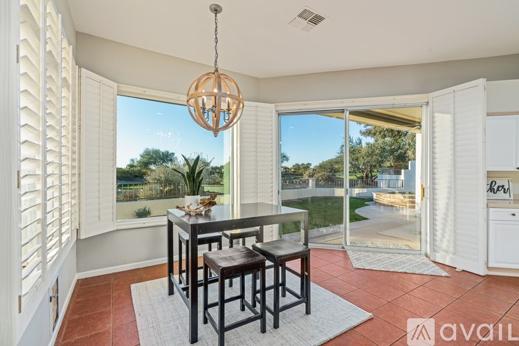 A dining area with a table and chairs is shown.