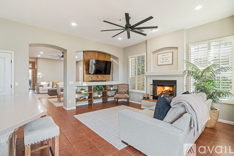 A living room with a fireplace and a television.