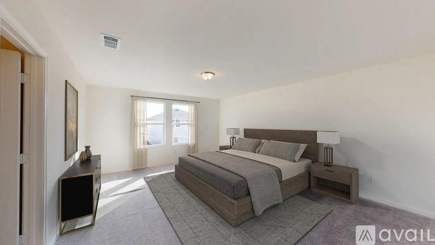 A bedroom with a large bed and a flat screen TV.