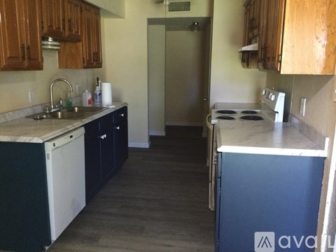 A kitchen with a white sink and a white dishwasher.