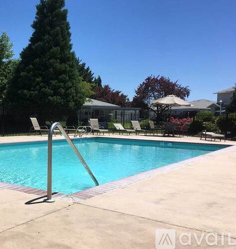 A pool with a diving board and a slide.