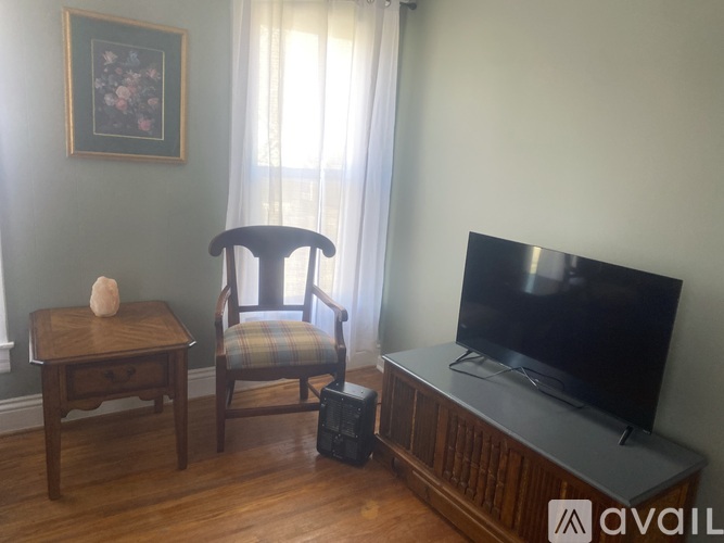 A chair sits in front of a television in a living room.