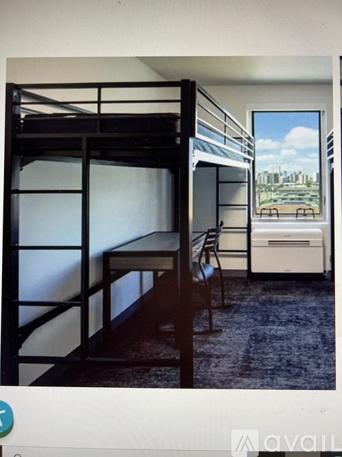 A room with a bunk bed and a chair.