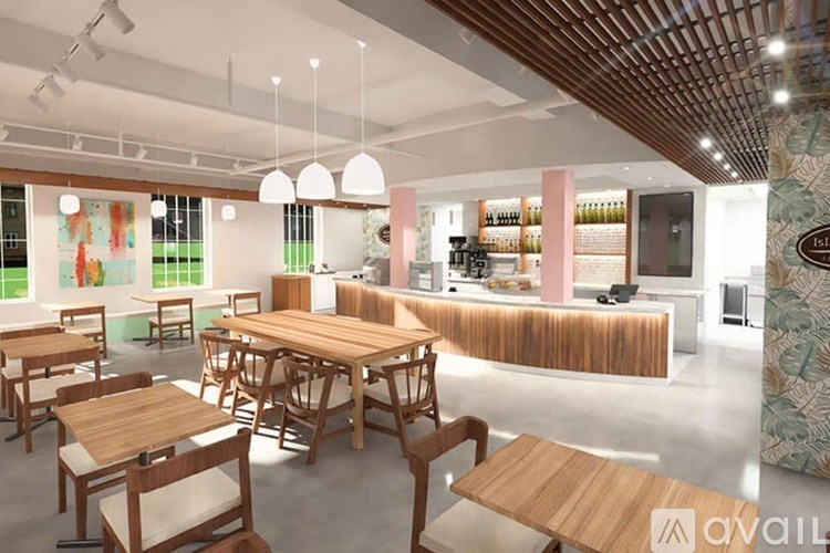 A modern dining area with wooden furniture and pendant lights.