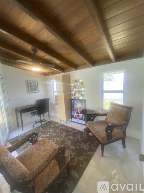 A living room with a brown chair and a brown rug.