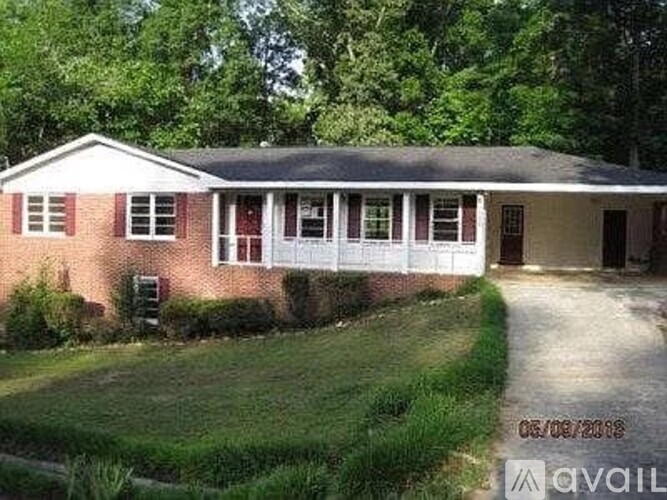 A house with a brick exterior and a white door is for sale.