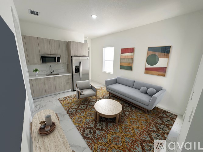 A living room with a grey couch, a wooden coffee table, and a rug with a geometric pattern.