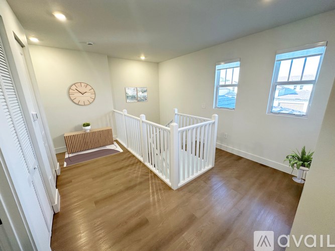 A baby's room with a white crib and a wooden floor.