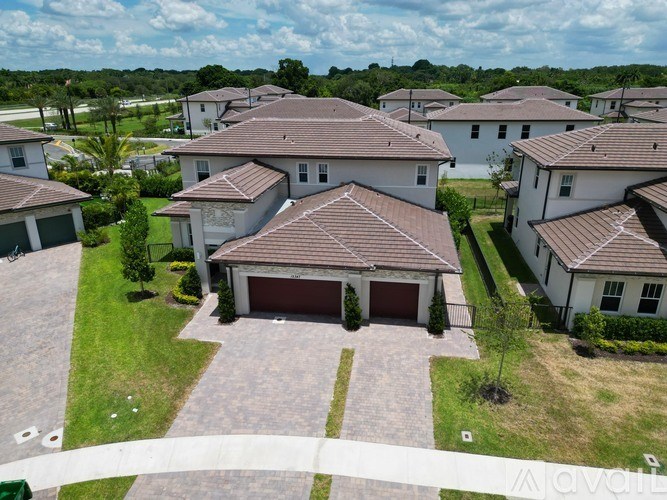 A row of houses with a driveway in the foreground.