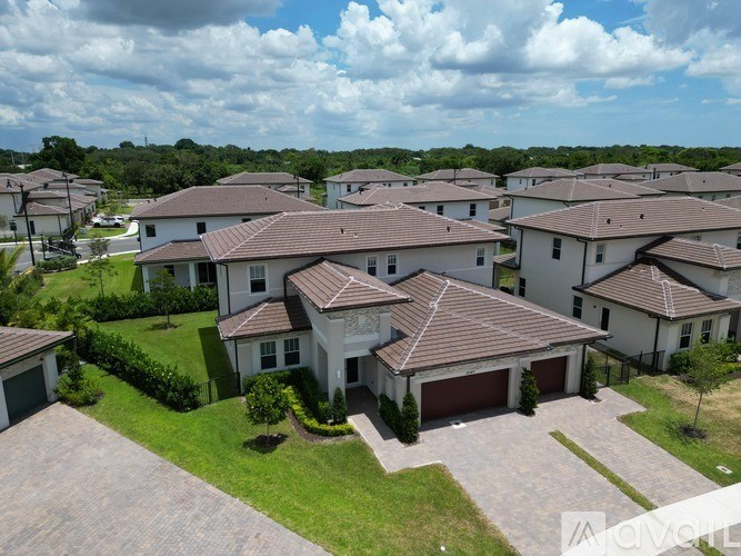 A row of houses with brown roofs and white walls.