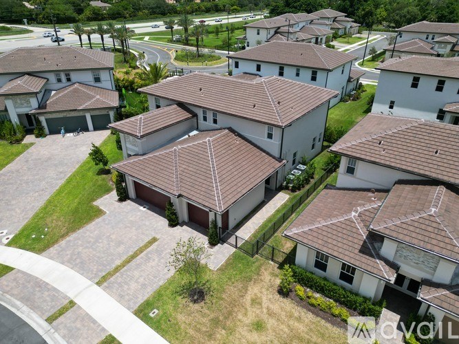 A bird's eye view of a neighborhood with houses and a street.