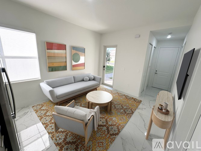 A living room with a couch, chair, and a rug.