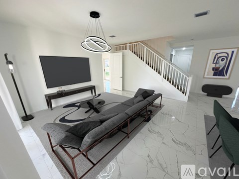 A living room with a grey sofa and a television.