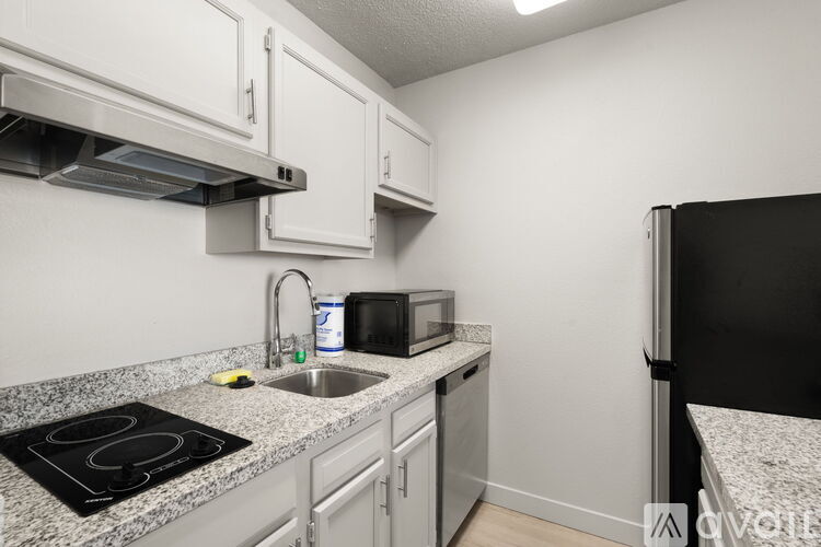 A kitchen with granite countertops and stainless steel appliances.
